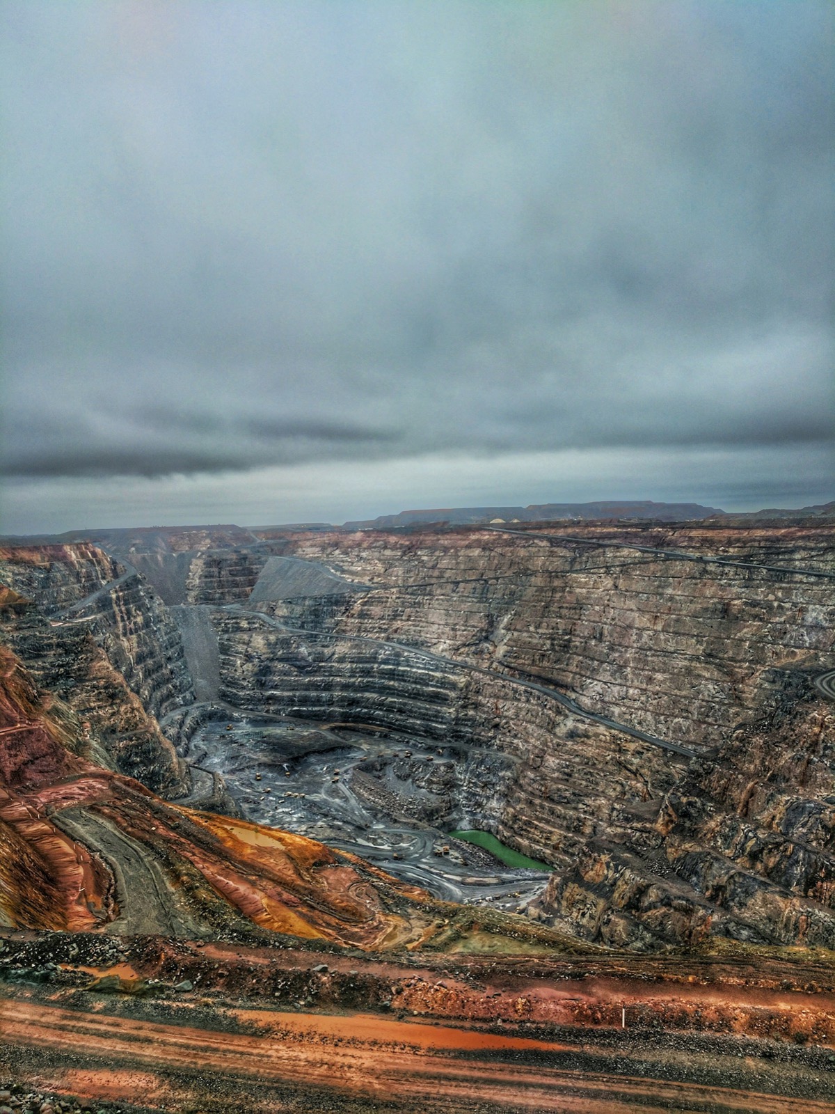 Open-pit mine showing a haul road descending into the pit