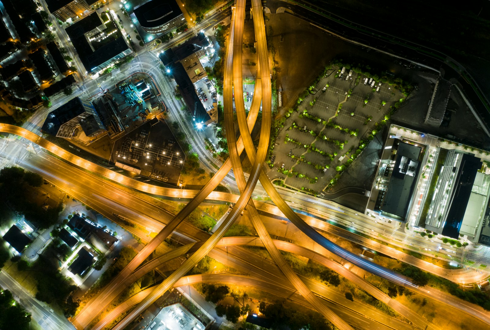 Aerial view of moving vehicles on a busy urban road at night