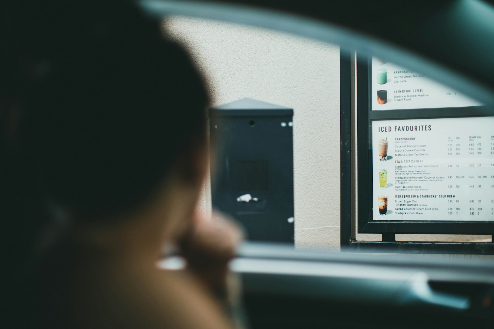 A dash-mounted smartphone capturing the road ahead from inside a vehicle